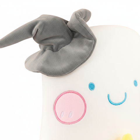 Close-up detail of halloween ghost plush toy face on white background